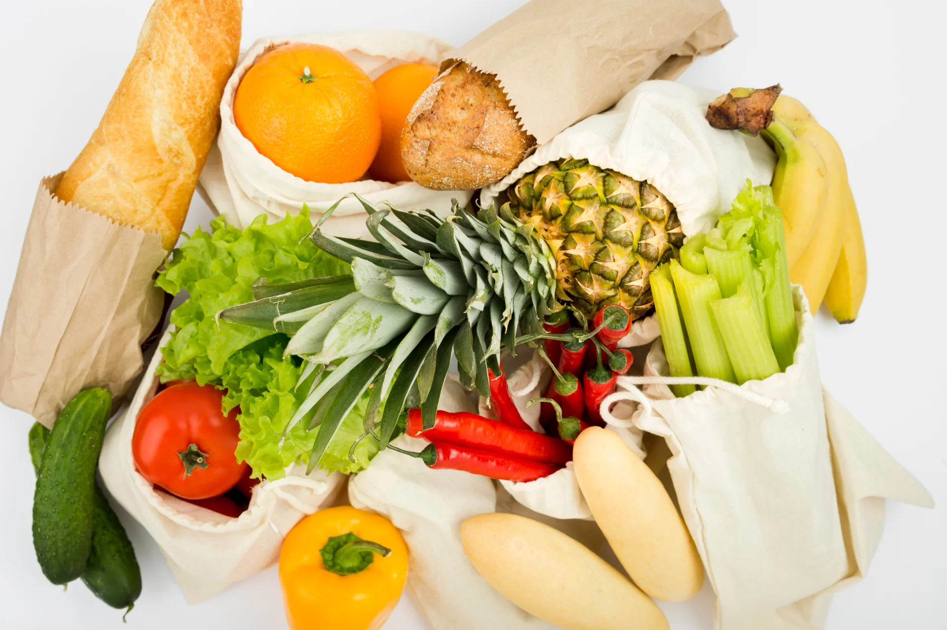 top view fruit vegetables reusable bags with bread