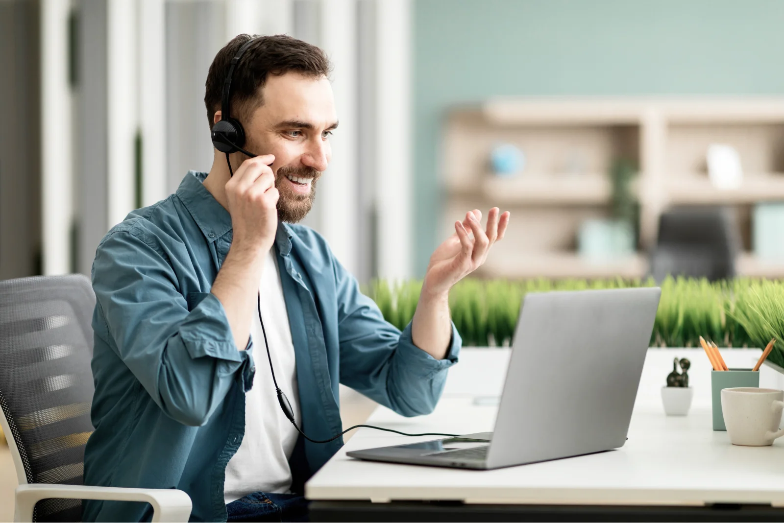 video conference male office employee headset having web call laptop 1